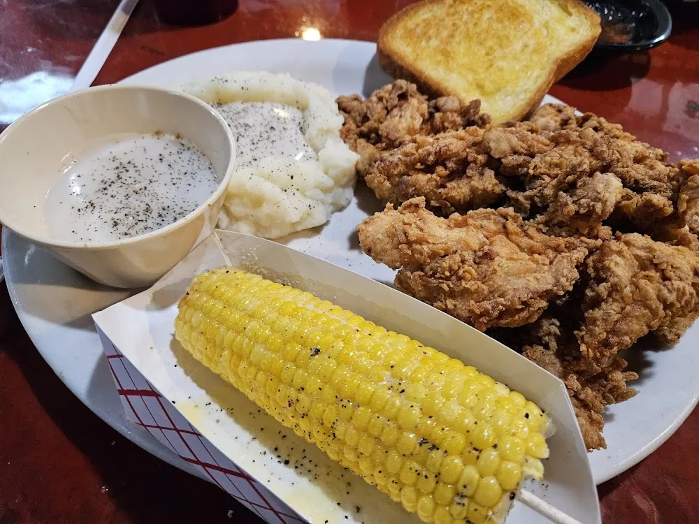 Chicken Straps Mashed Potatoes and Gravy Corn on the Cob